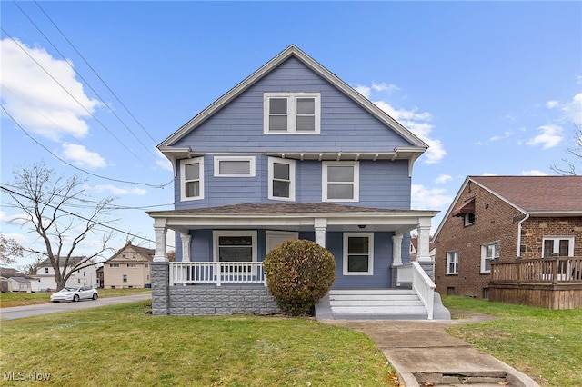 traditional style home with a porch and a front lawn