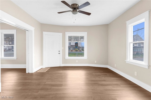 entrance foyer featuring wood finished floors, a ceiling fan, and baseboards