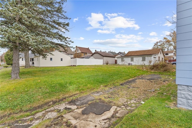 view of yard featuring a residential view and fence