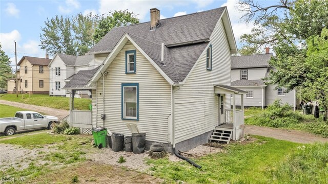 452 E Summit St, Alliance, OH 44601 - rear view of property featuring roof with shingles and a chimney