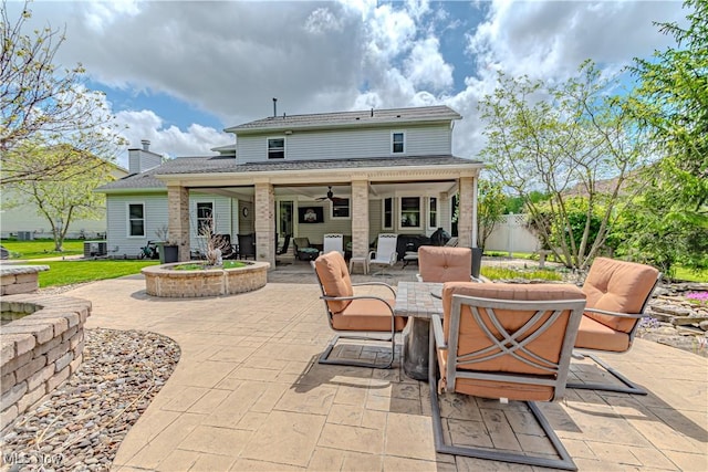 rear view of property with a patio area, ceiling fan, fence, and outdoor dining area