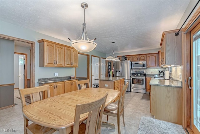 dining room with light tile patterned flooring and a textured ceiling