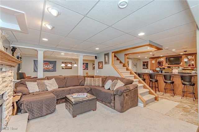 living room with decorative columns and stairway