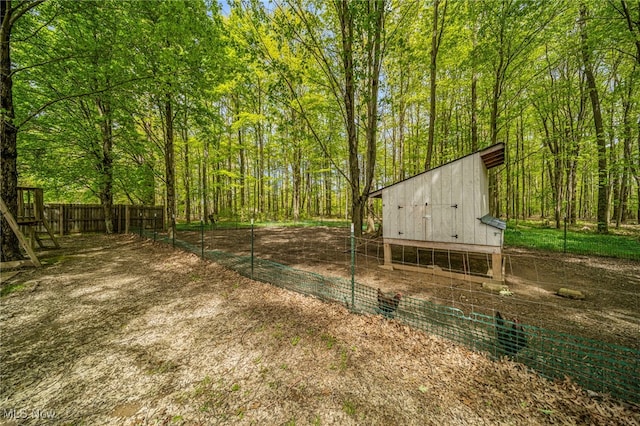 4946 Ireland Rd, Rome, OH 44085 - view of yard featuring exterior structure, an outdoor structure, fence, and a view of trees