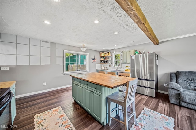 4946 Ireland Rd, Rome, OH 44085 - kitchen featuring butcher block countertops, green cabinetry, freestanding refrigerator, black / electric stove, and baseboards