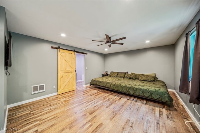 4946 Ireland Rd, Rome, OH 44085 - bedroom featuring a barn door, wood finished floors, baseboards, recessed lighting, and a ceiling fan