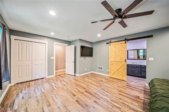 4946 Ireland Rd, Rome, OH 44085 - bedroom with a barn door, light wood-style flooring, baseboards, and recessed lighting