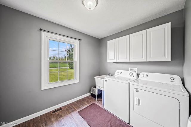 4946 Ireland Rd, Rome, OH 44085 - laundry area with cabinet space, washing machine and dryer, baseboards, and dark wood-type flooring
