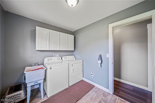 4946 Ireland Rd, Rome, OH 44085 - laundry room with washer and clothes dryer, cabinet space, wood finished floors, and baseboards