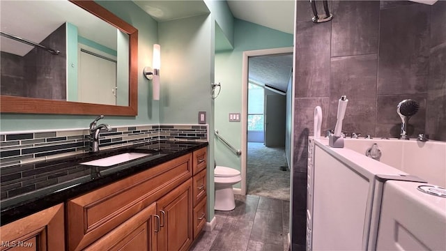 250 Laurel Cir Unit 13, Aurora, OH 44202 - bathroom featuring vanity, wood finished floors, vaulted ceiling, and backsplash
