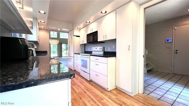 250 Laurel Cir Unit 13, Aurora, OH 44202 - kitchen with white appliances, recessed lighting, white cabinetry, and light wood-style flooring