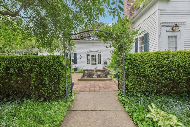 view of exterior entry featuring french doors
