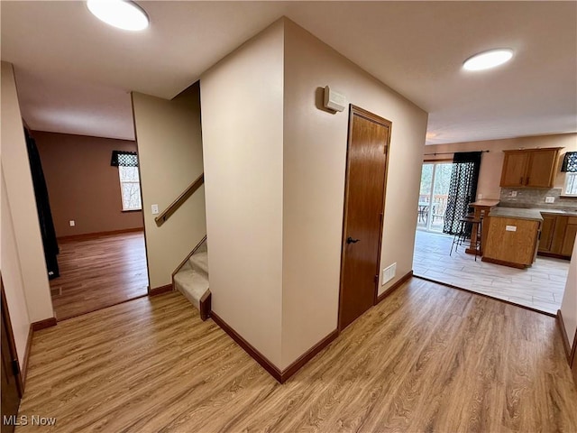 36 Choctaw Trl, Malvern, OH 44644 - corridor featuring light wood-type flooring, baseboards, and stairs