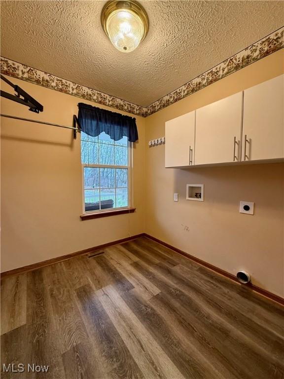 36 Choctaw Trl, Malvern, OH 44644 - laundry room with a textured ceiling, wood finished floors, washer hookup, hookup for an electric dryer, and cabinet space