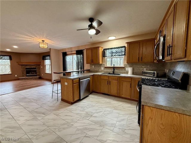 36 Choctaw Trl, Malvern, OH 44644 - kitchen featuring stainless steel appliances, a sink, a peninsula, light marble finish floors, and open floor plan