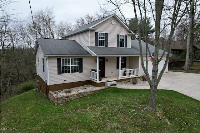36 Choctaw Trl, Malvern, OH 44644 - view of front of home with a porch, driveway, a front yard, and a garage