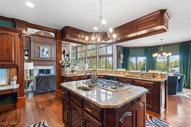 7384 Braucher St NW, North Canton, OH 44720 - kitchen featuring a chandelier, a sink, an island with sink, dark wood-style flooring, and recessed lighting