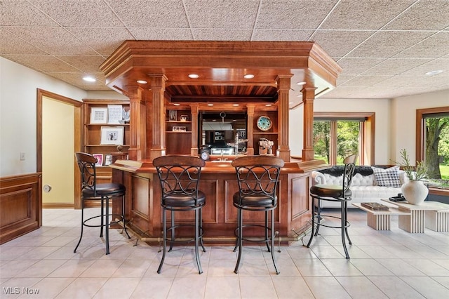 7384 Braucher St NW, North Canton, OH 44720 - indoor bar featuring decorative columns and light tile patterned floors