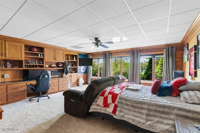 7384 Braucher St NW, North Canton, OH 44720 - carpeted bedroom with multiple windows, a paneled ceiling, wood walls, and ceiling fan