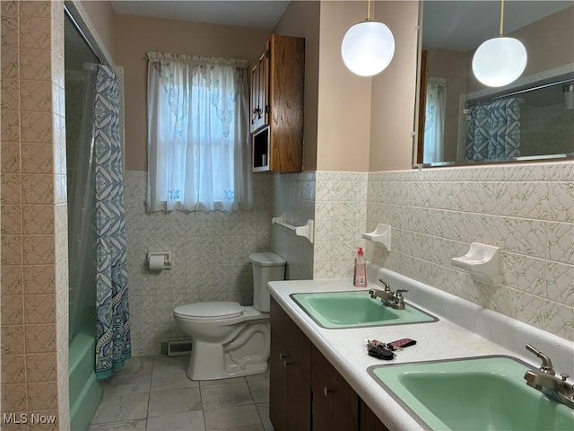 260 Miller Ave, Weirton, WV 26062 - full bath featuring tile walls, tile patterned flooring, toilet, a wainscoted wall, and shower / tub combo with curtain