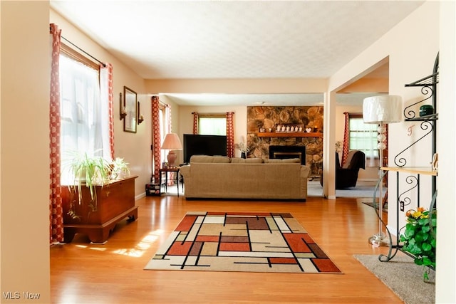 7969 Bricker Rd NW, Massillon, OH 44646 - living area featuring wood finished floors, a fireplace, and baseboards