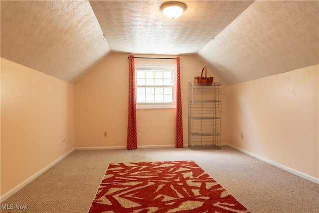 7969 Bricker Rd NW, Massillon, OH 44646 - bonus room featuring a textured ceiling, carpet flooring, vaulted ceiling, and baseboards