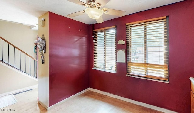 10219 Spinnaker Run, Aurora, OH 44202 - unfurnished room featuring wood finished floors, ceiling fan, baseboards, and stairs