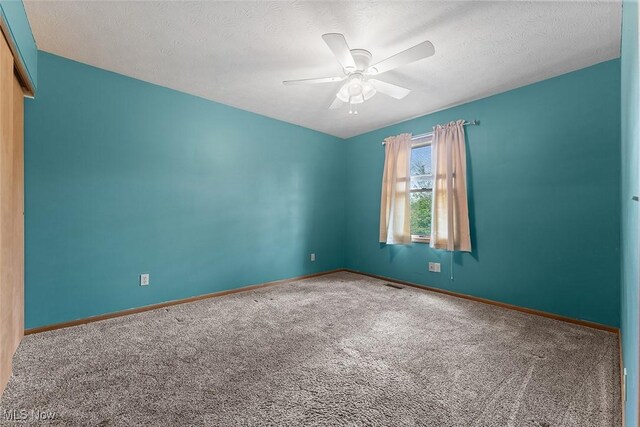 67 Chestnut Ave, Northfield, OH 44067 - carpeted spare room with ceiling fan, baseboards, and a textured ceiling