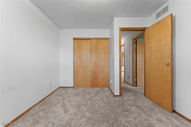 67 Chestnut Ave, Northfield, OH 44067 - unfurnished bedroom with carpet, a closet, baseboards, and a textured ceiling