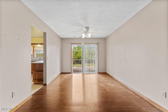 67 Chestnut Ave, Northfield, OH 44067 - empty room with ceiling fan, wood finished floors, a textured ceiling, and baseboards