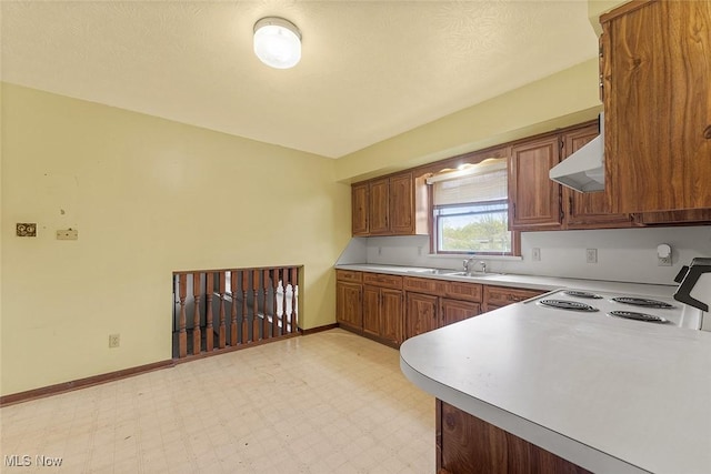 67 Chestnut Ave, Northfield, OH 44067 - kitchen with under cabinet range hood, white electric stove, light floors, and brown cabinets
