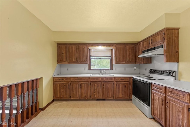 67 Chestnut Ave, Northfield, OH 44067 - kitchen featuring white range with electric cooktop, under cabinet range hood, a sink, light countertops, and light floors
