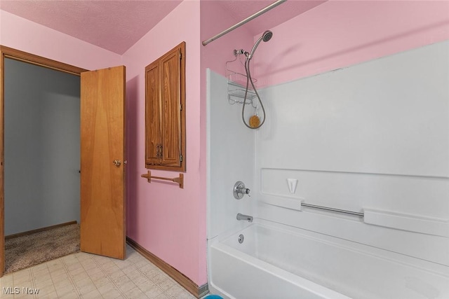 67 Chestnut Ave, Northfield, OH 44067 - bathroom featuring baseboards, washtub / shower combination, tile patterned floors, and a textured ceiling