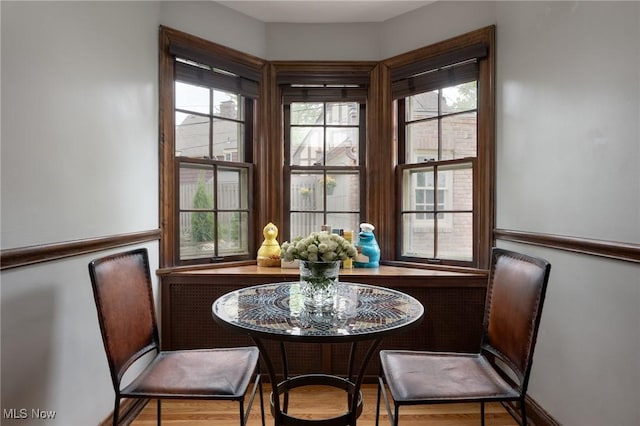 dining room with healthy amount of natural light and wood finished floors
