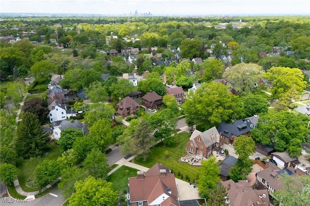 aerial view of property and surrounding area featuring nearby suburban area