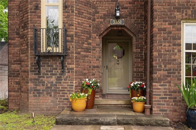 property entrance featuring brick siding