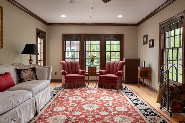 living room featuring light wood-style flooring, healthy amount of natural light, ornamental molding, baseboards, and recessed lighting
