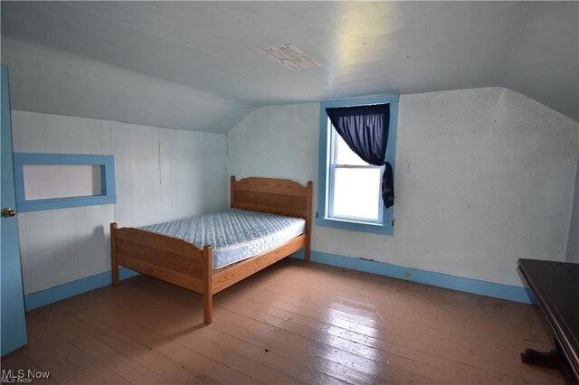 7833 Pymatuning Lake Rd, Williamsfield, OH 44093 - bedroom with lofted ceiling, wood-type flooring, and baseboards