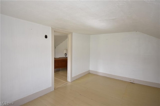 7833 Pymatuning Lake Rd, Williamsfield, OH 44093 - empty room with baseboards, a textured ceiling, and lofted ceiling