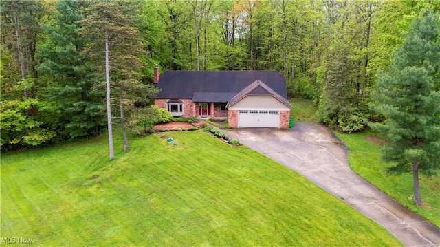 8665 Prescott Dr, Chesterland, OH 44026 - view of front of property featuring brick siding, concrete driveway, a front lawn, an attached garage, and a chimney