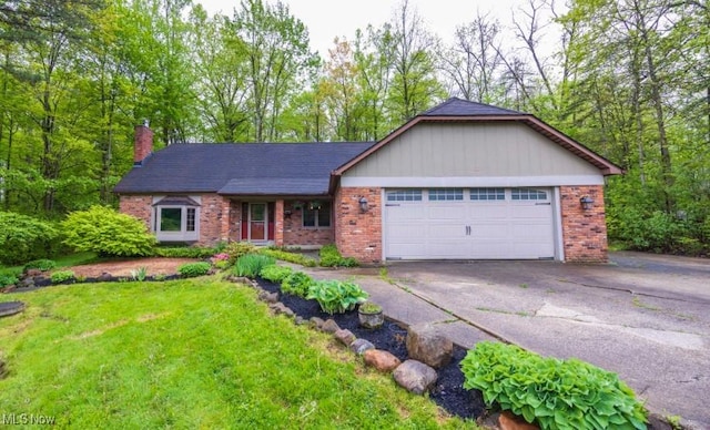 8665 Prescott Dr, Chesterland, OH 44026 - single story home with brick siding, driveway, a chimney, and a front lawn