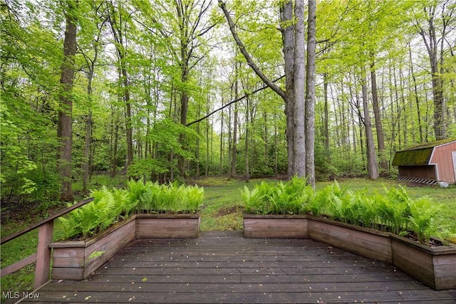 8665 Prescott Dr, Chesterland, OH 44026 - wooden deck with a view of trees and an outbuilding