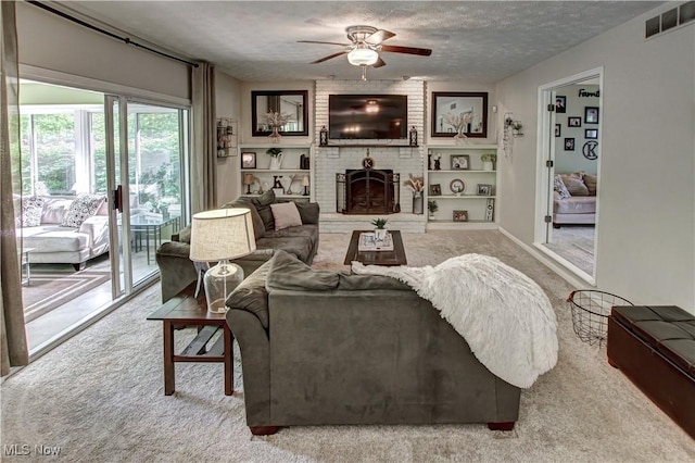 650 Thornhill Ln, Aurora, OH 44202 - living area with carpet, a ceiling fan, a textured ceiling, and a brick fireplace