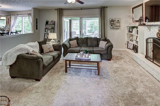 650 Thornhill Ln, Aurora, OH 44202 - carpeted living room featuring a ceiling fan, a textured ceiling, baseboards, and a brick fireplace