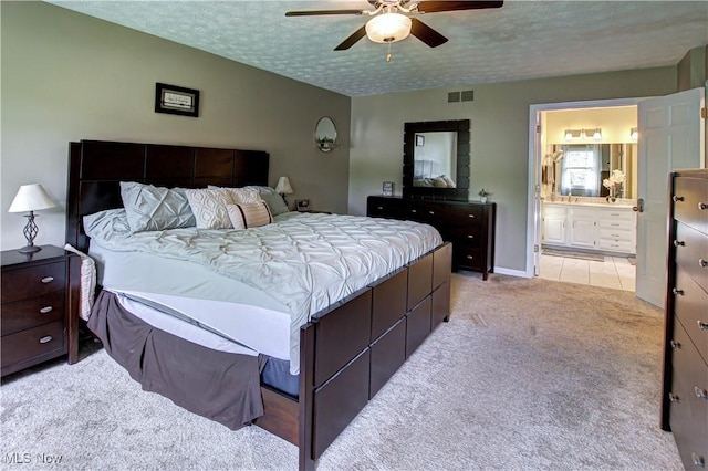 650 Thornhill Ln, Aurora, OH 44202 - bedroom with light colored carpet, a textured ceiling, connected bathroom, a ceiling fan, and baseboards