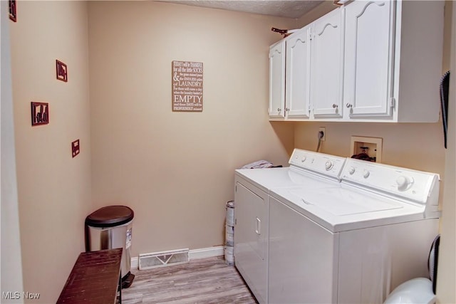 650 Thornhill Ln, Aurora, OH 44202 - laundry room featuring cabinet space, washer and dryer, light wood finished floors, and baseboards