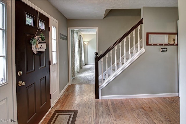 650 Thornhill Ln, Aurora, OH 44202 - foyer entrance featuring baseboards, wood finished floors, and stairway