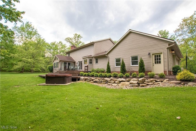 650 Thornhill Ln, Aurora, OH 44202 - rear view of house featuring a deck, a chimney, a lawn, and a hot tub