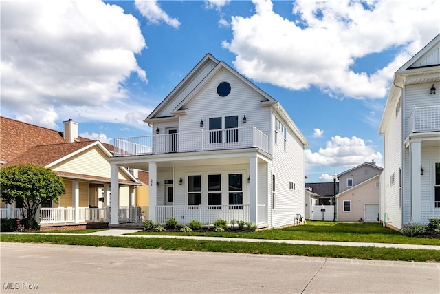 374 Bascule Dr, Lorain, OH 44052 - view of front of house with a balcony, a porch, and a front lawn