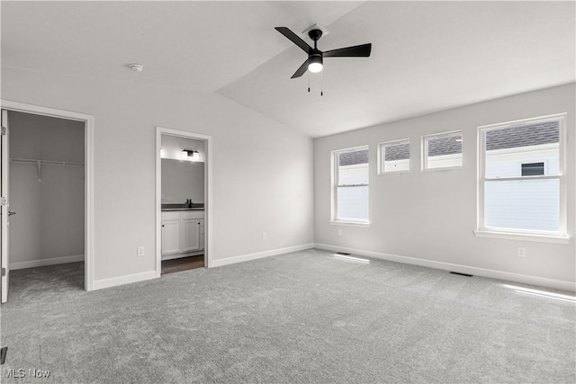 374 Bascule Dr, Lorain, OH 44052 - unfurnished bedroom with vaulted ceiling, carpet, a spacious closet, a closet, and ensuite bath